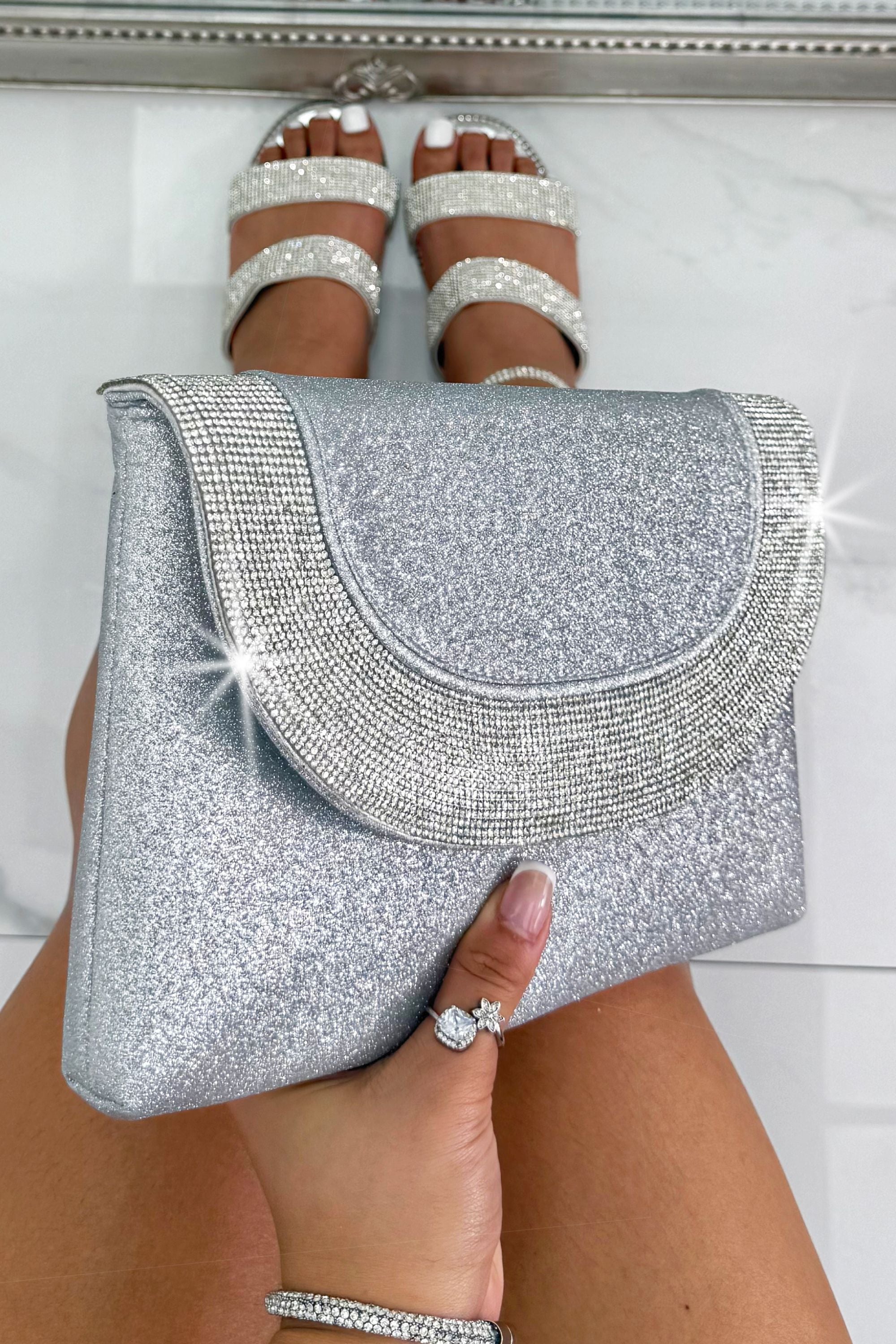 Glitter Luxe Metallic Crystal Envelope Clutch Bag Silver, showing sleek envelope-style flap with crystal embellished detail perfect for evening styling with a glamorous metallic shimmer finish.
