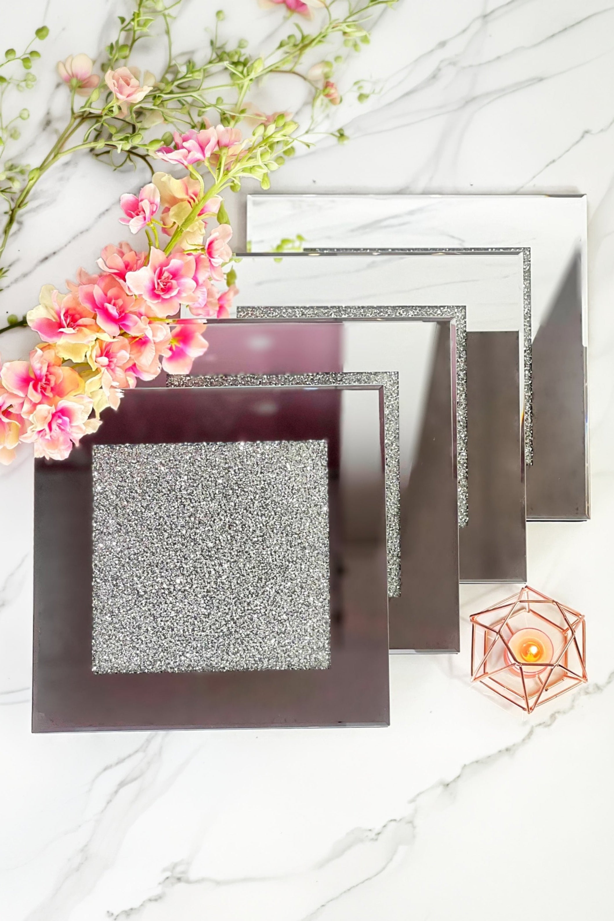A set of four glittering coasters against a marble backdrop