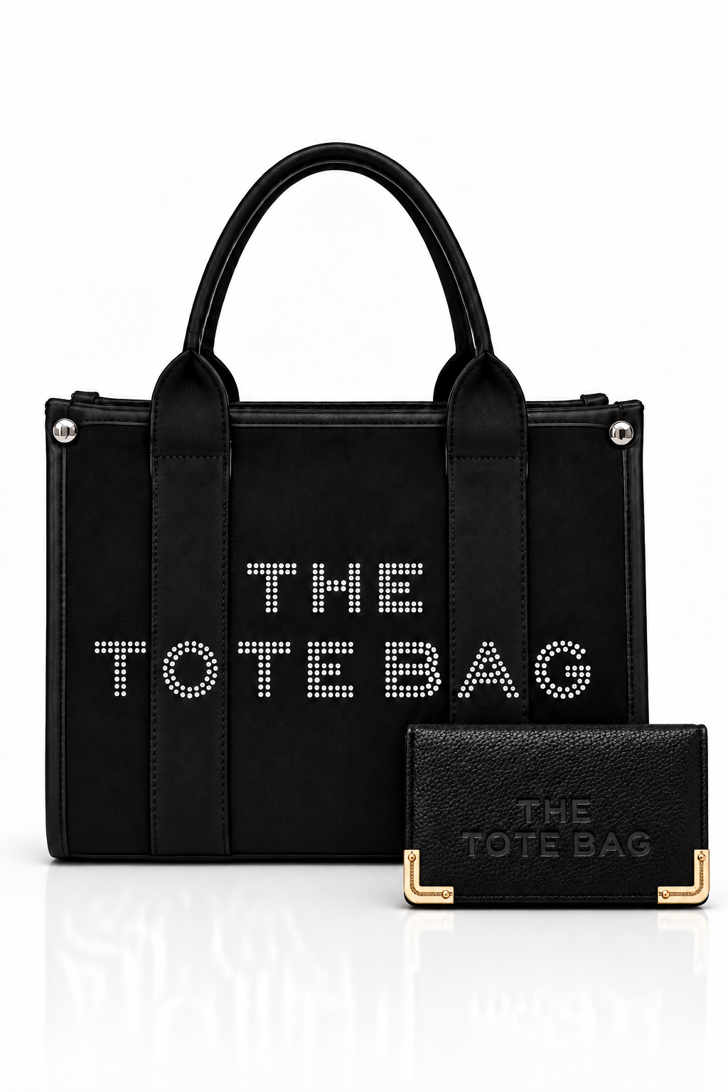Black, structured tote bag with short rounded handles, textured panel, silver-tone stud details and embellished "THE TOTE BAG" lettering on the front, paired with matching black textured wallet with gold tone corner protectors.