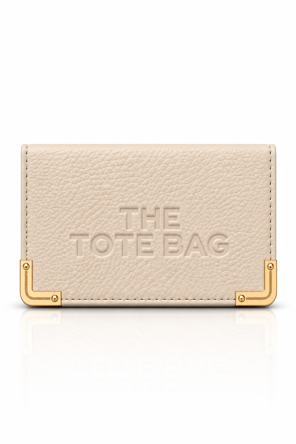 Nude faux leather Tote purse with embossed The Tote Bag lettering on front, textured finish, and gold-tone metal corner protectors with visible rivet detailing.Set against a plain white background.