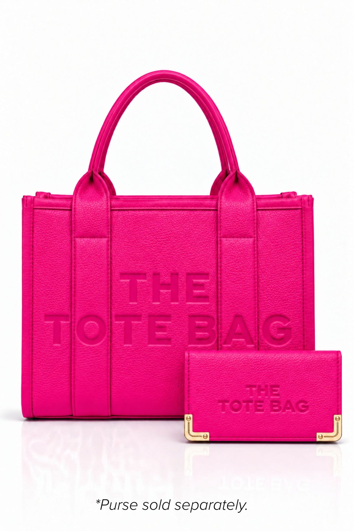 Hot Pink faux leather structured tote bag with two rounded top handles, embossed. "THE TOTE BAG" lettering on the front, vertical stitched panels, contrast edging stud details.