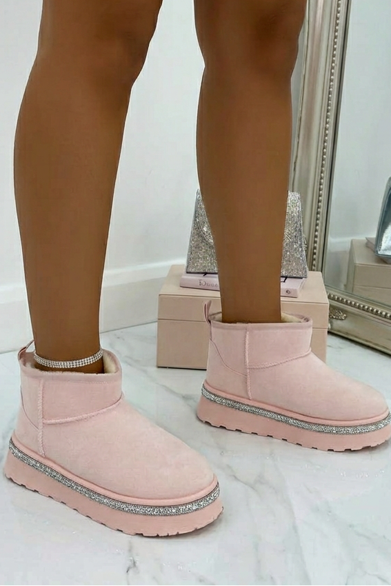 Person wearing pink platform boots in a stylish interior setting.