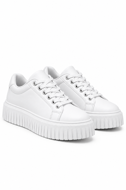 A pair of white low-top platform sneakers with white laces and thick, ribbed white soles, shown on a clean white background.