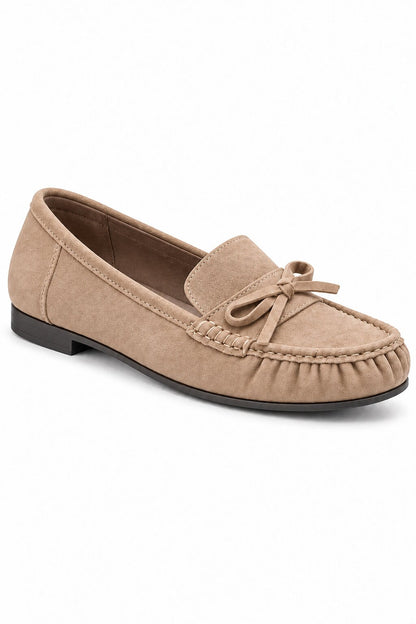 A single taupe suede moccasin loafer with a small bow on the vamp, shown from a three-quarters angle against a plain white background.