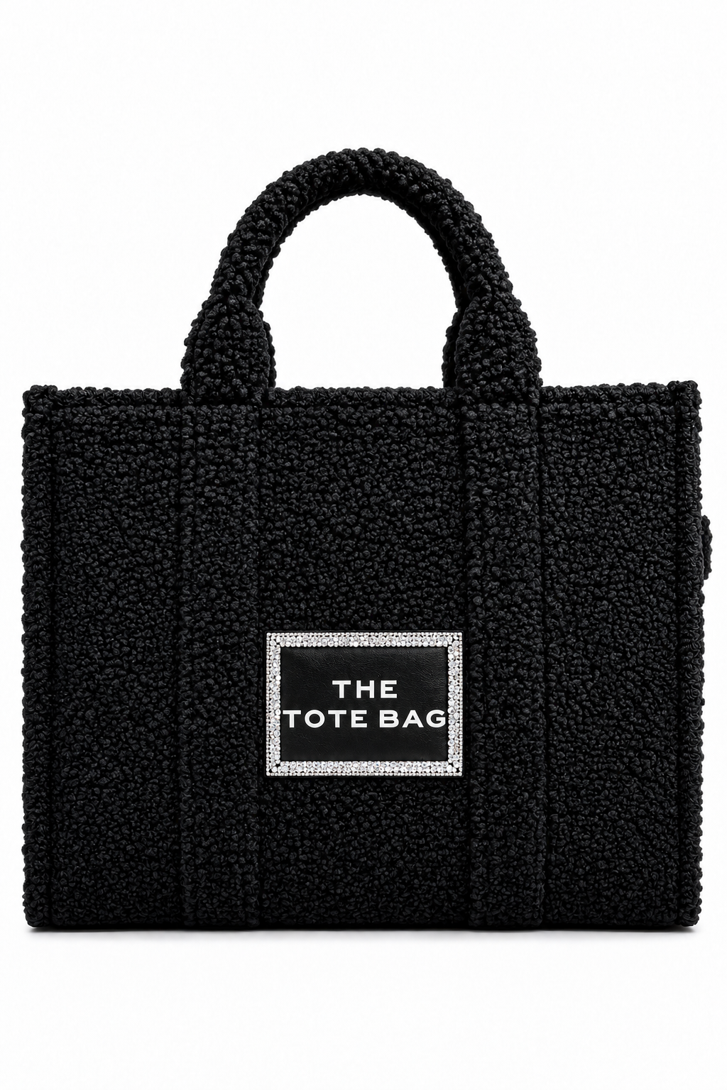 A black textured teddy-bundle tote bag with two top handles and a central silver-bordered label that reads &