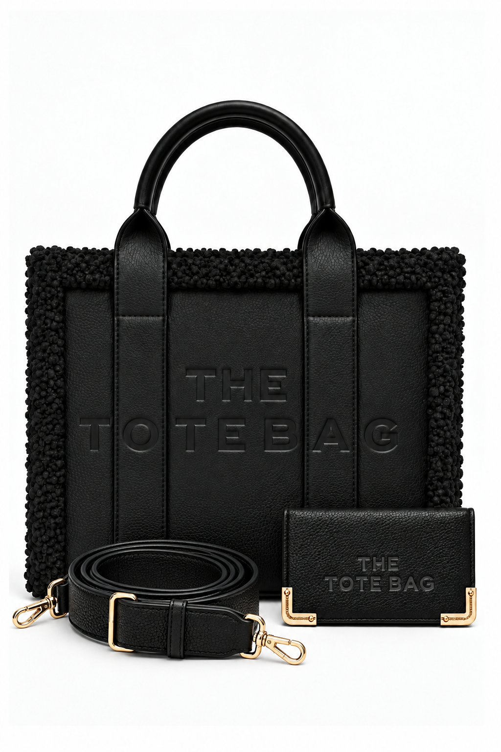 Black tote bag bundle featuring a structured handbag with rounded top handles, textured trim, and embossed "THE TOTE BAG" lettering. Includes a matching black purse with gold-tone corner detailing and an adjustable, detachable shoulder strap with gold tone clips. 