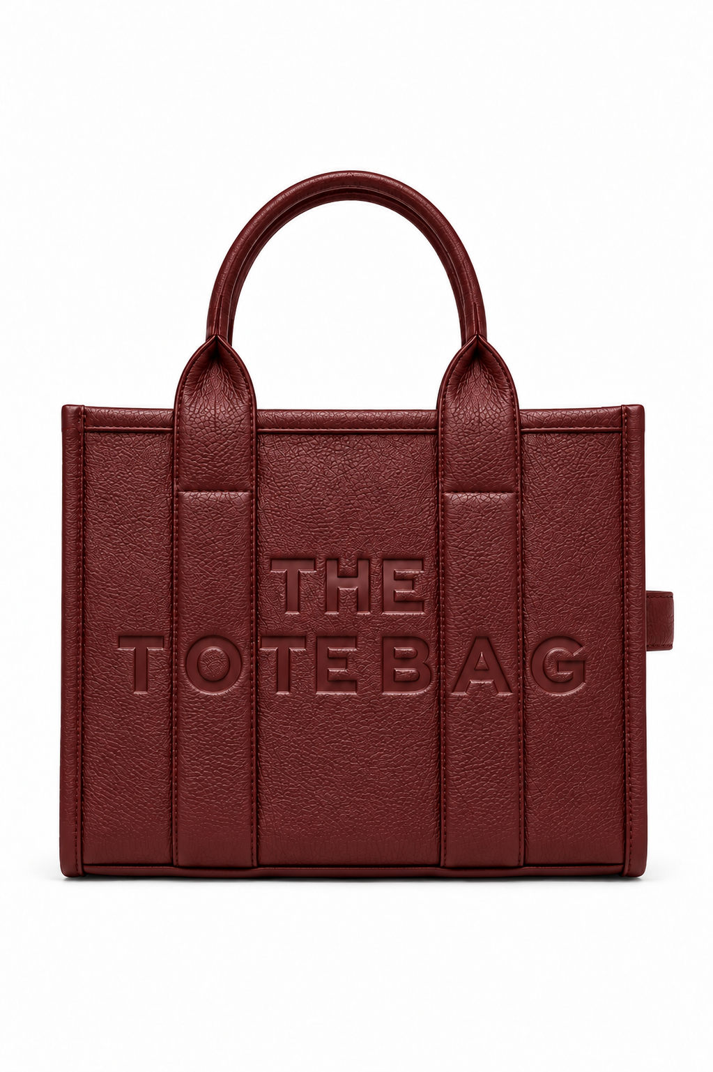 Burgundy Faux leather tote bag with two rounded top handles, embossed "THE TOTE BAG" lettering on the front, contrast stitching. gold tone hardware. Set against a white background.