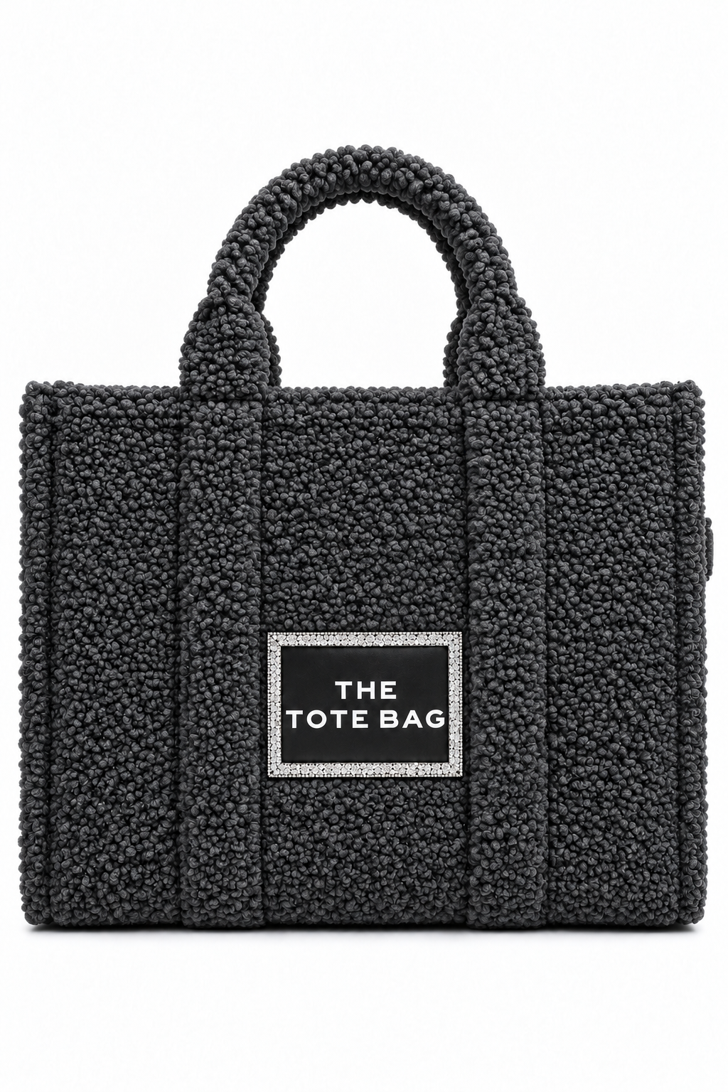 A black bouclé tote bag with dual top handles and a central black label outlined in rhinestones that reads &