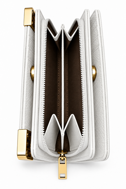 White textured tote purse shown from the side, featuring multiple accordion-style compartments, a central zippered section with white zip trim and gold-tone zipper pull and metal hardware. 