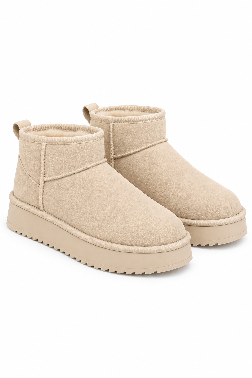 A pair of beige suede ankle boots with thick platform soles, shown from a three-quarters angle on a white background.