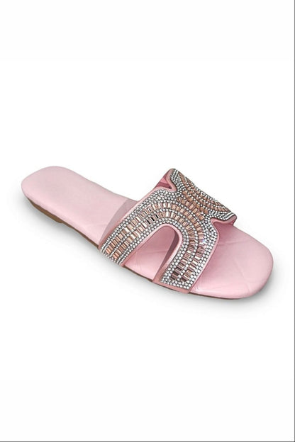 Pink slide sandal with embellishments on a white background