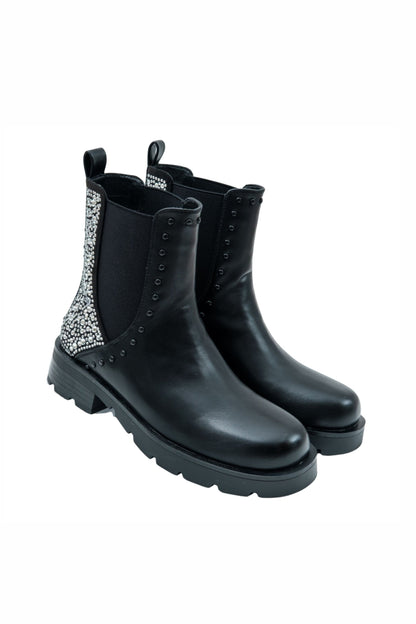 Black Chelsea boots with decorative elements on a white background