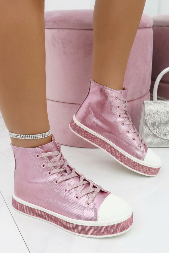 Pink high-top sneakers worn with white socks on a light background