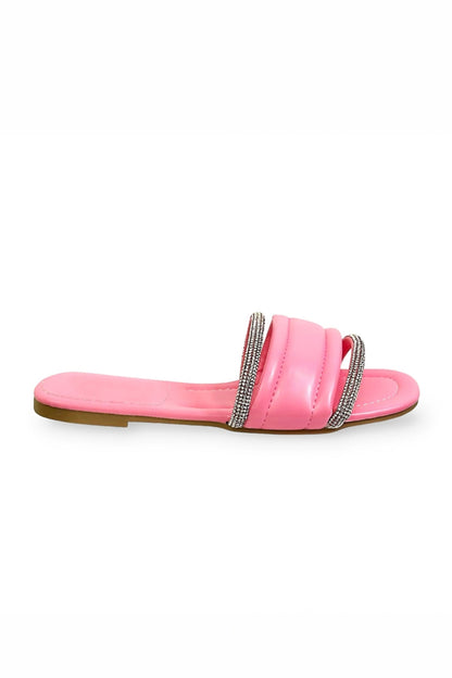 Pink sandal with a decorative strap on a white background