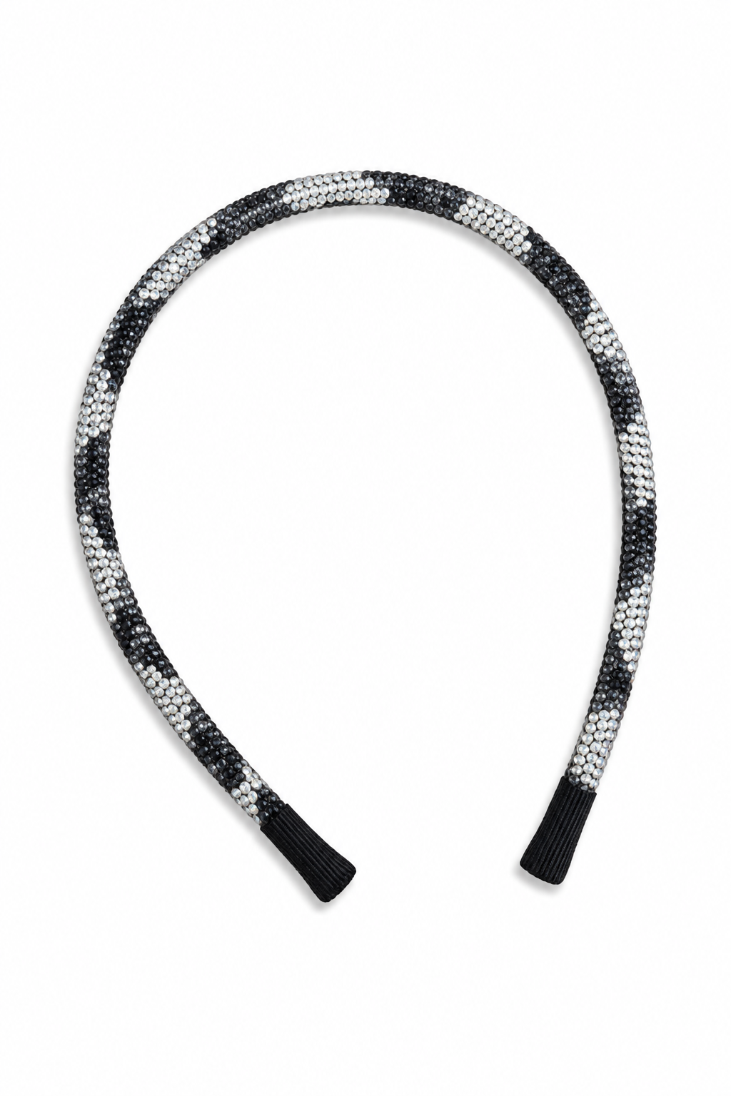 A braided headband with a black and white woven pattern and black ribbed end caps, shown on a plain white background.