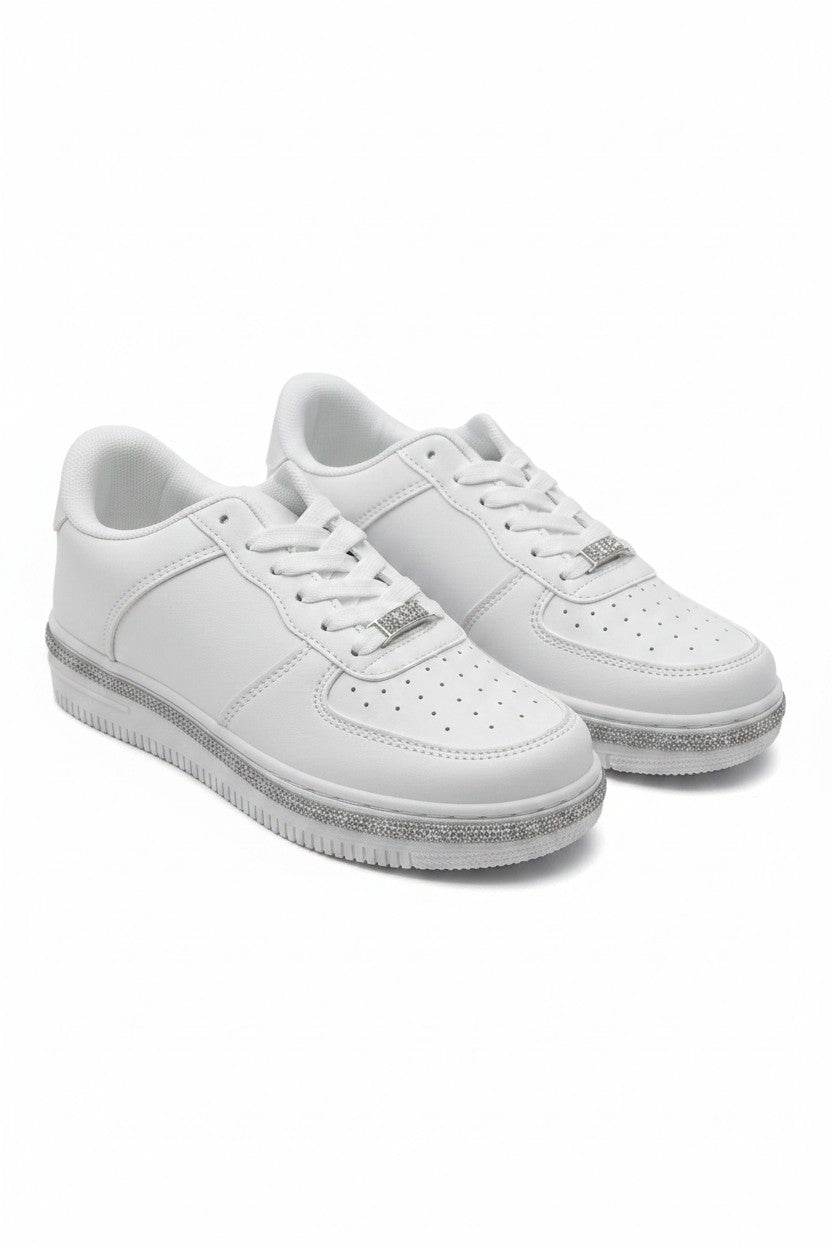 A pair of white low-top sneakers with silver glittery soles and silver metal logo accents on the sides, displayed against a clean white background.