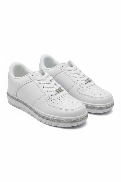 A pair of white low-top sneakers with silver glittery soles and silver metal logo accents on the sides, displayed against a clean white background.