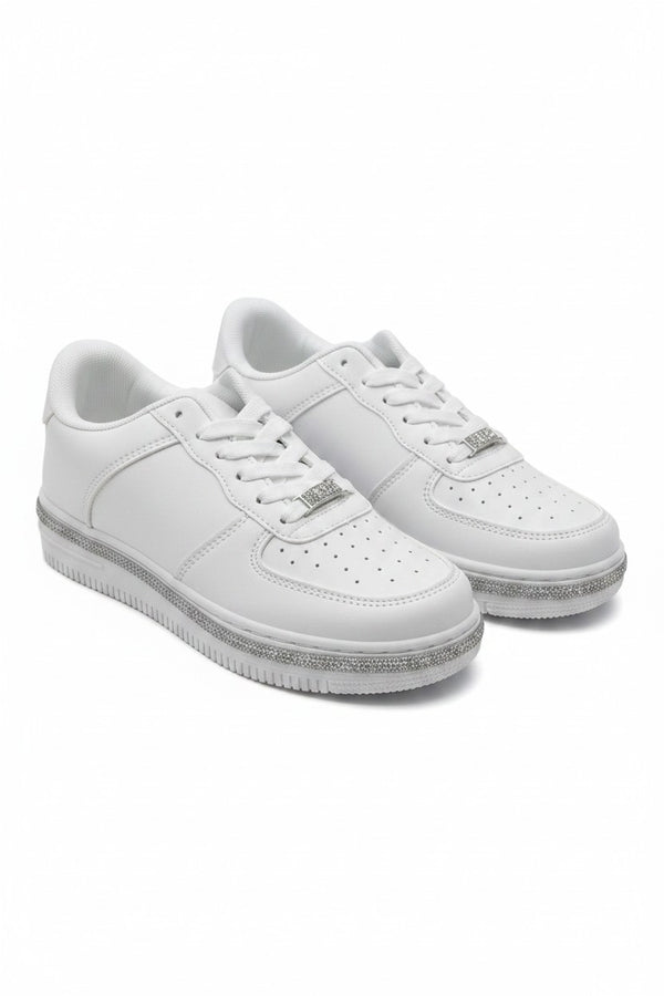 A pair of white low-top sneakers with silver glittery soles and silver metal logo accents on the sides, displayed against a clean white background.