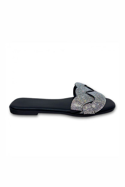 Black sandal with a decorative strap on a white background