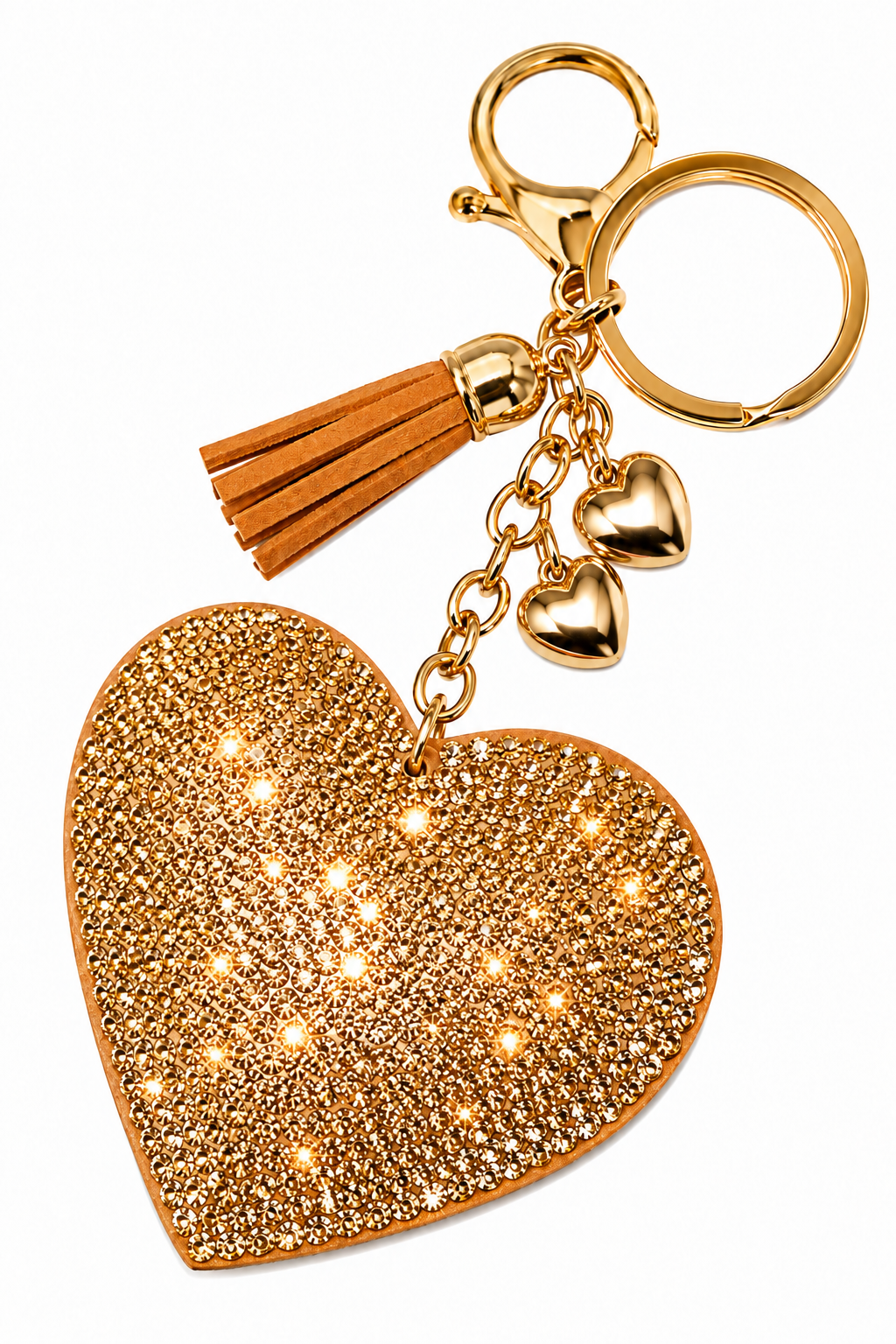 A gold heart-shaped keychain charm covered in sparkling rhinestones, featuring a gold-tone clasp, split key ring, two small heart charms, and a brown faux-leather tassel, shown on a plain white background.