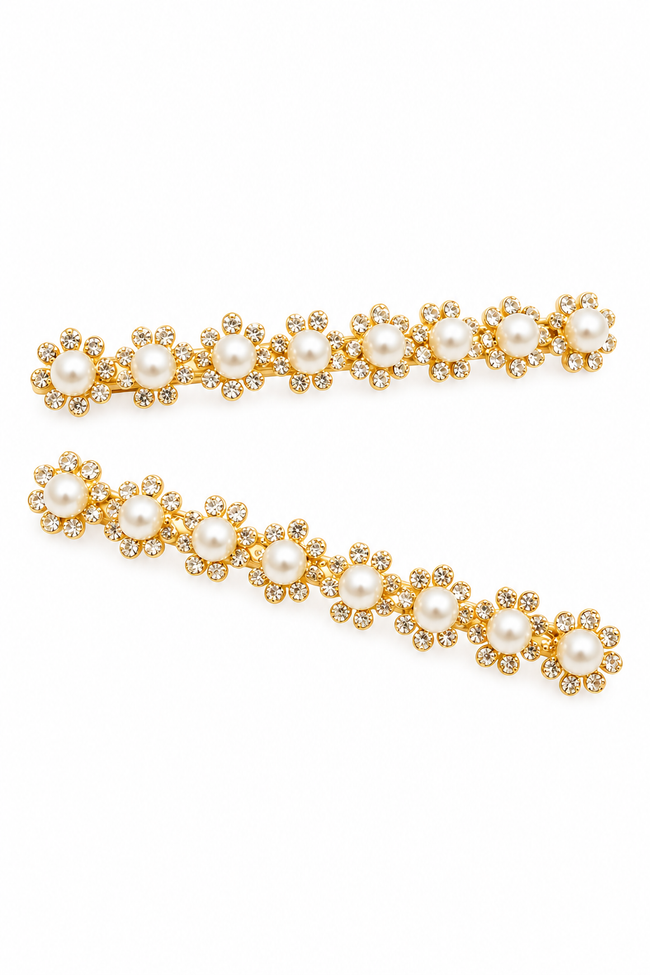Two gold hair clips decorated with faux pearls and small clear rhinestones in a floral daisy pattern, displayed on a clean white background.