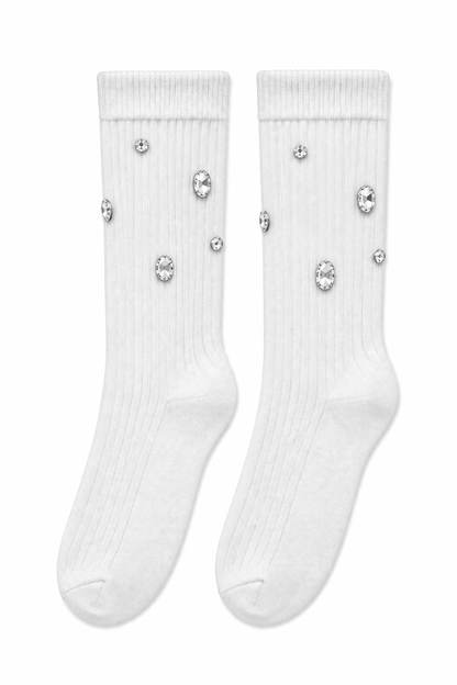 A pair of white ribbed crew socks decorated with scattered clear rhinestone embellishments, shown against a plain white background.