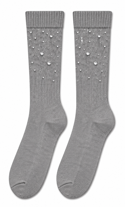 A pair of light gray ribbed crew socks decorated with small silver rhinestones on the upper leg, displayed against a plain white background.