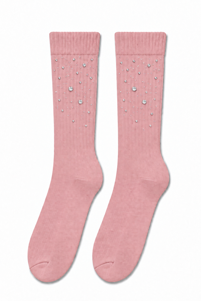 A pair of pink ribbed crew socks decorated with small silver rhinestone embellishments, displayed flat against a plain white background.