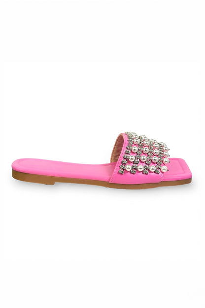Pink slide sandal with pearl embellishments on a white background