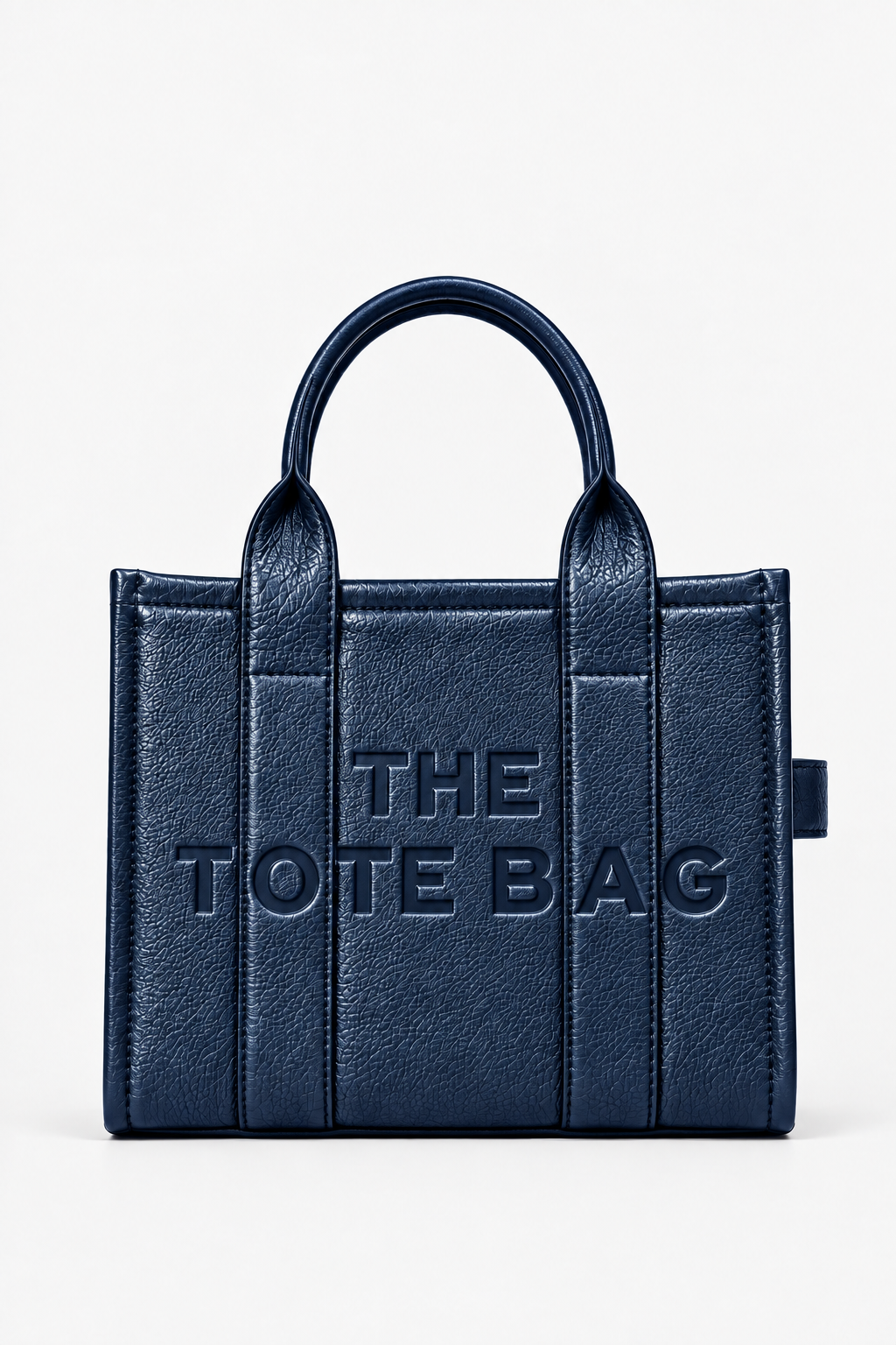 A navy blue faux-leather tote bag with embossed vertical panel details and the text &