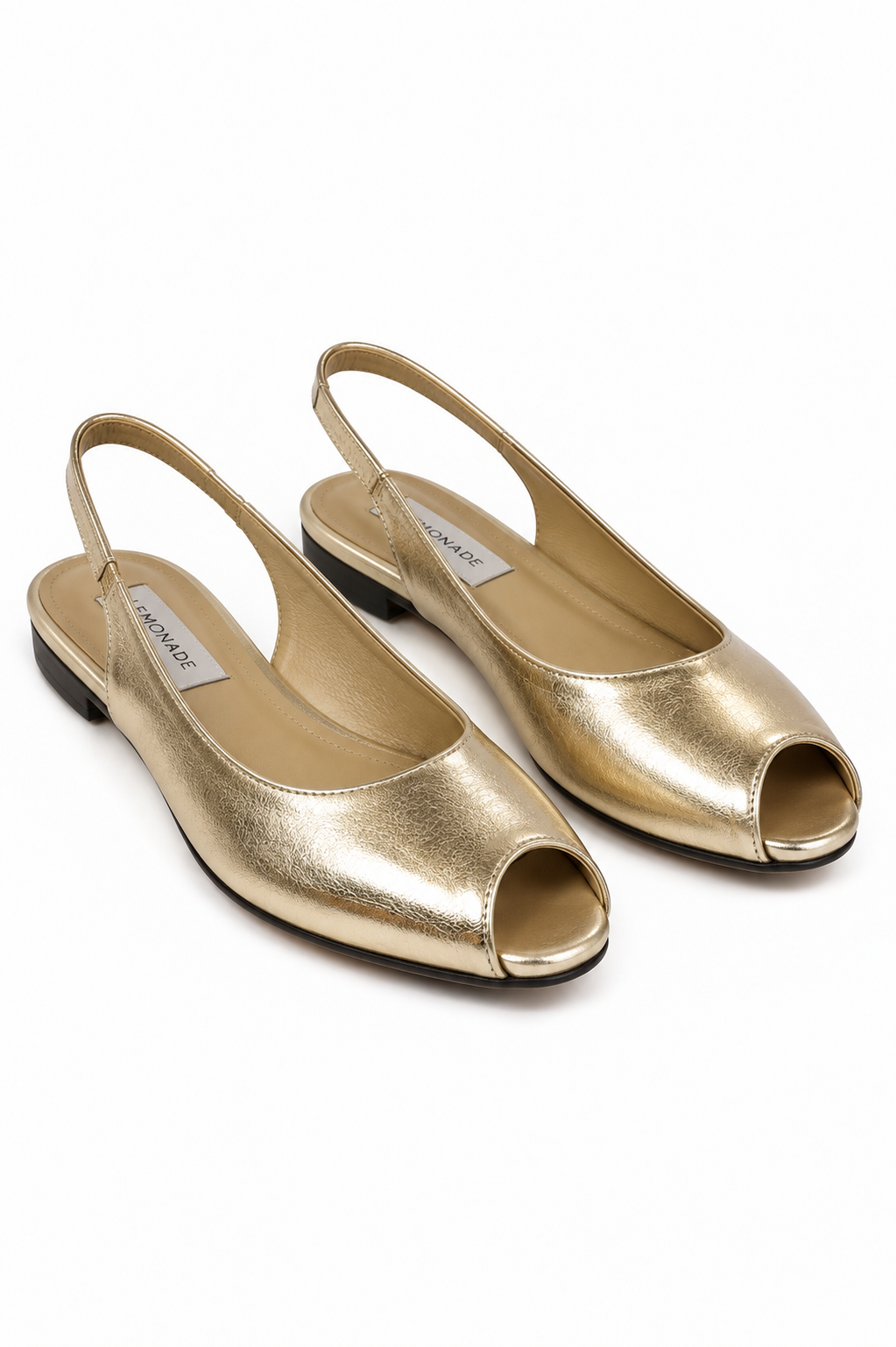 A pair of metallic gold slingback flat shoes with open toes, displayed on a clean white background.