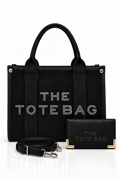 Black, structured tote bag with short rounded handles, textured panel, silver-tone stud details and embellished "THE TOTE BAG" lettering on the front, paired with matching black textured wallet with gold tone corner protectors with a matching shoulder strap.