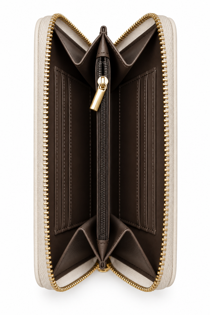 Side view of gold zip-around purse featuring gold tone zipper teeth, a matching gold zip pull and beige accordion- style interior with multiple compartments. 