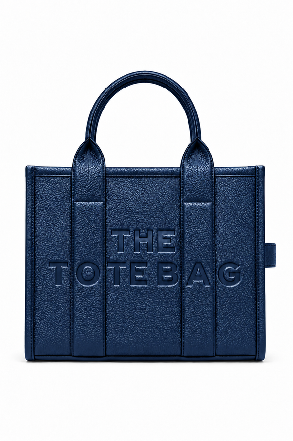 A navy blue faux-leather tote bag with embossed vertical panel details and the text &