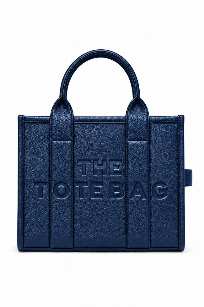 A navy blue faux-leather tote bag with embossed vertical panel details and the text &