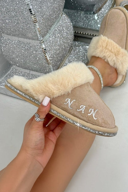 Beige slippers with fur trim held by a hand