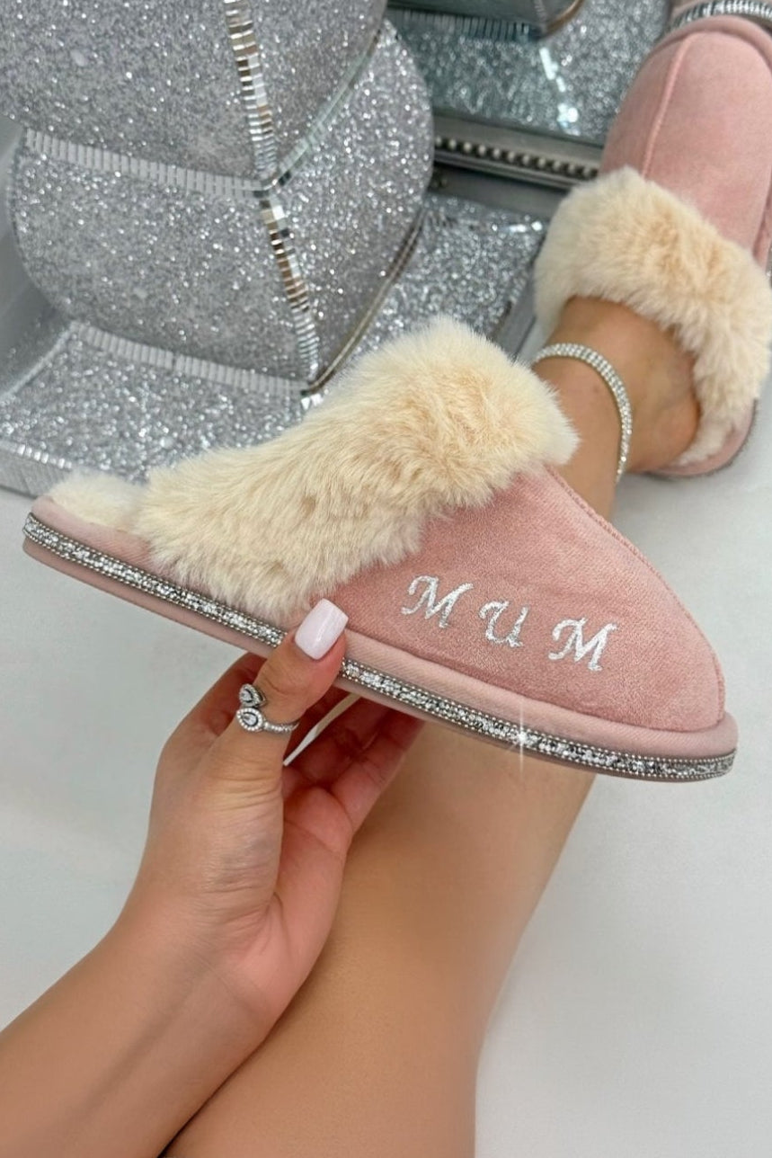 Personalised pink slipper held in the hand