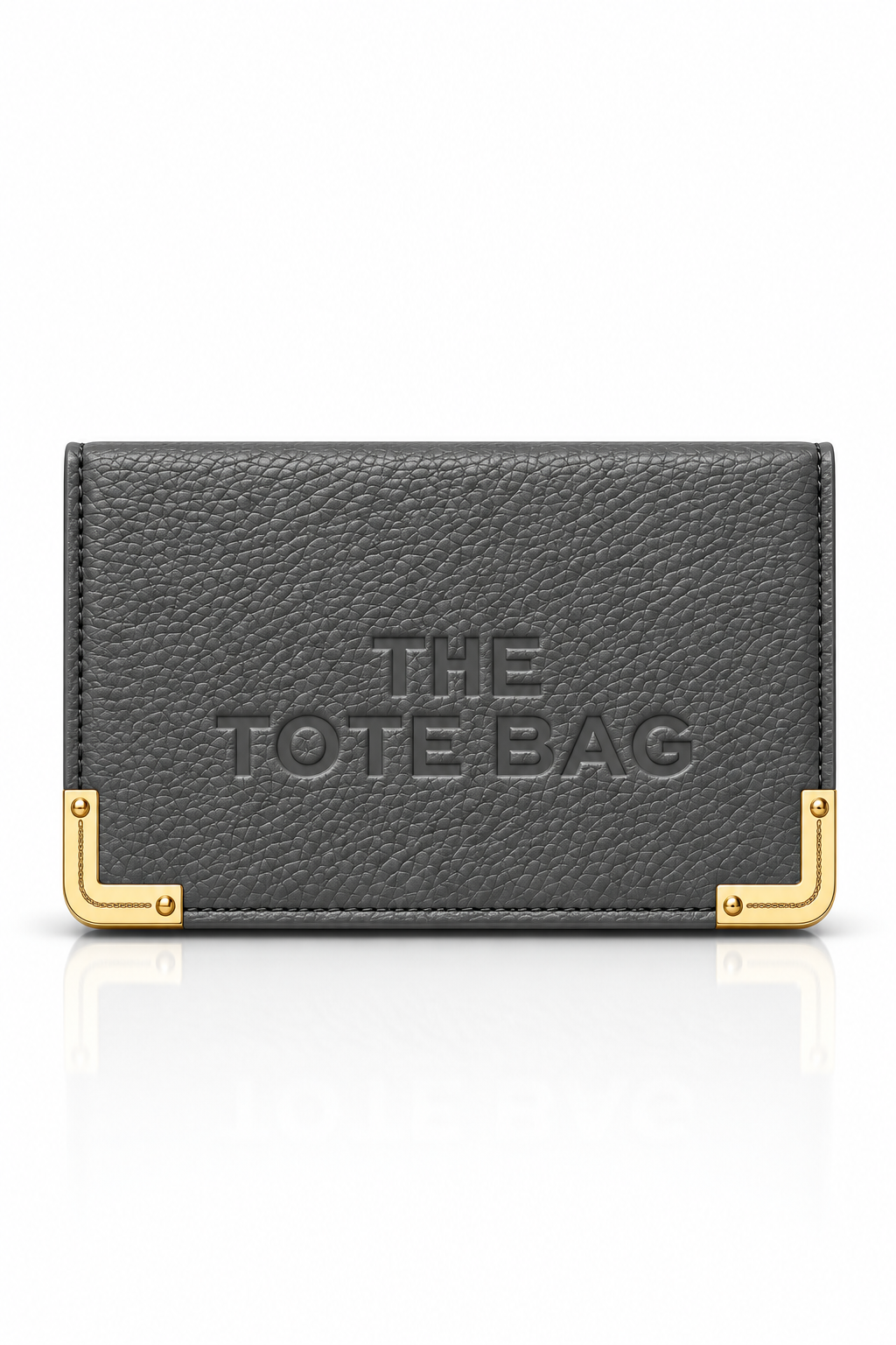 Charcoal grey textured tote purse with embossed "The Tote Bag" lettering on the front and gold tone metal corner protectors with rivet detailing. 