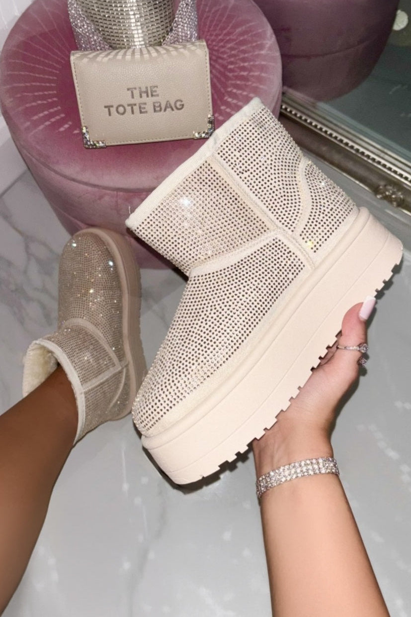Person wearing sparkly platform shoes with a matching tote bag purse