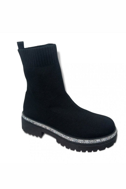 Black sock boot with a glittery sole on a white background