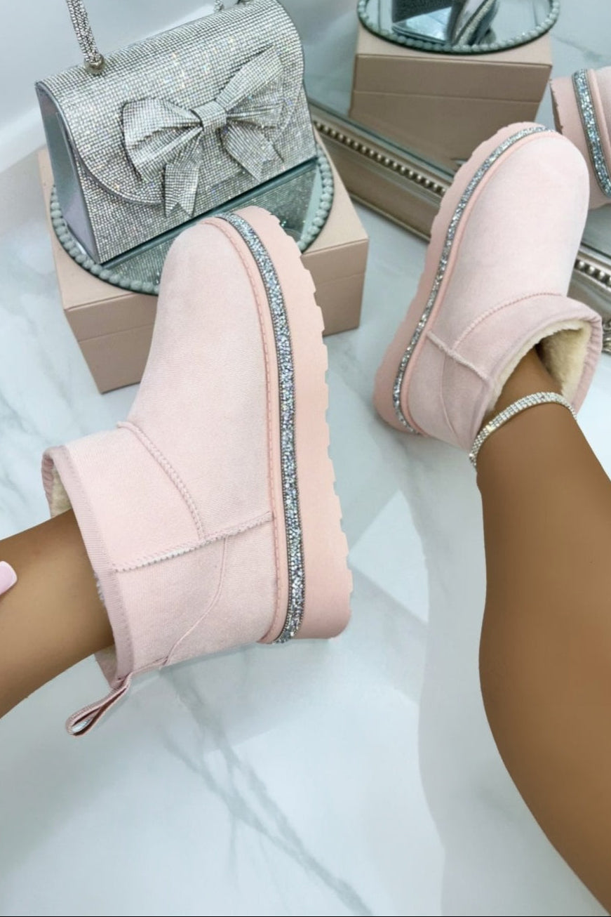 Pink slipper boots with decorative elements on a white background
