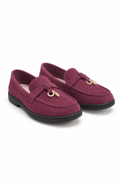 A pair of burgundy suede penny loafers with gold-tone metal horsebit details and black soles, displayed on a clean white background.