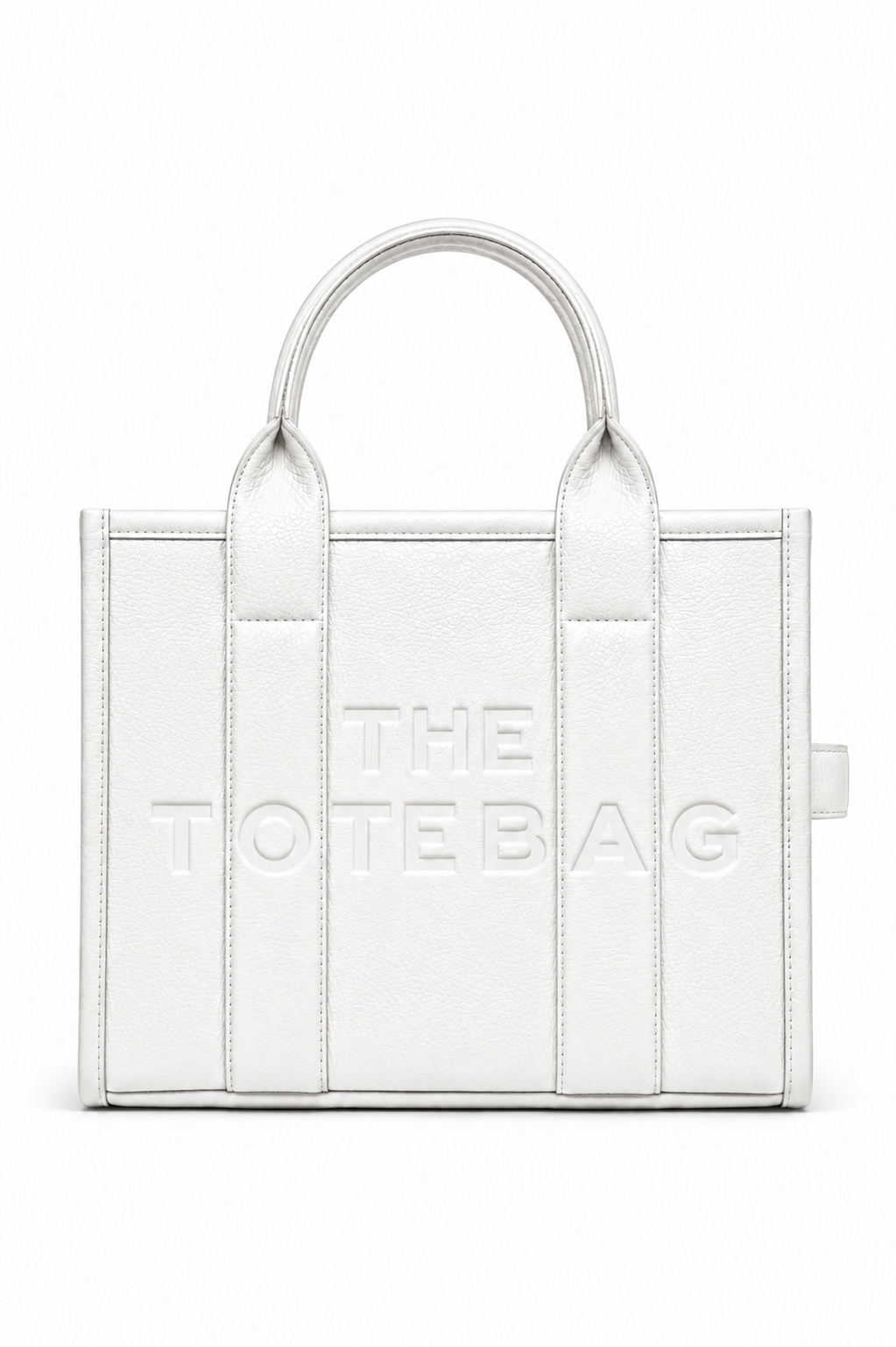 Medium white faux leather structured tote bag with two rounded top handles, embossed. "THE TOTE BAG" lettering on the front, vertical stitched panels. Pictured on a white background. 