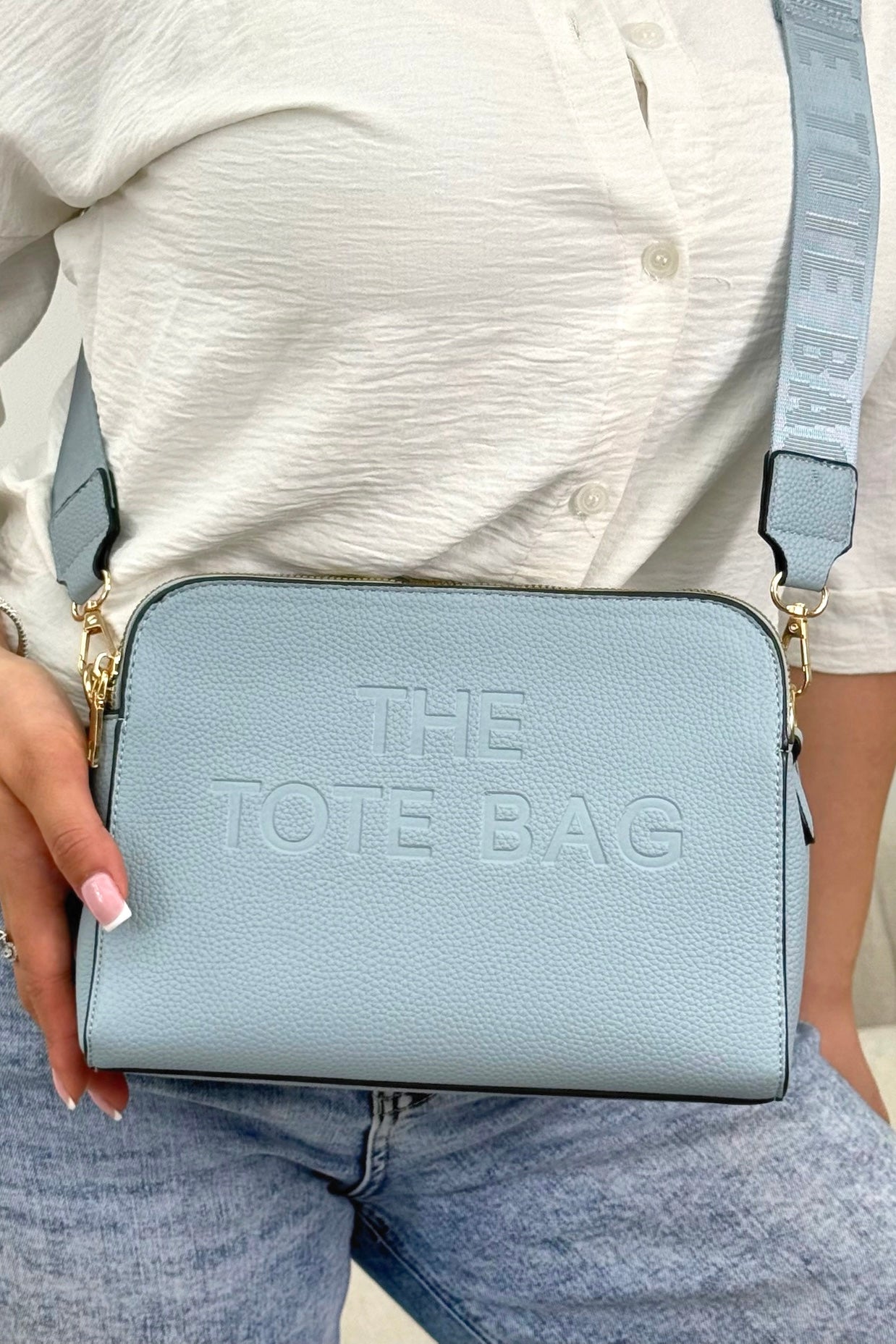 Faux Leather Triple Compartment Everyday Crossbody Tote Bag Blue finished with structured silhouette with modern embossed slogan detail