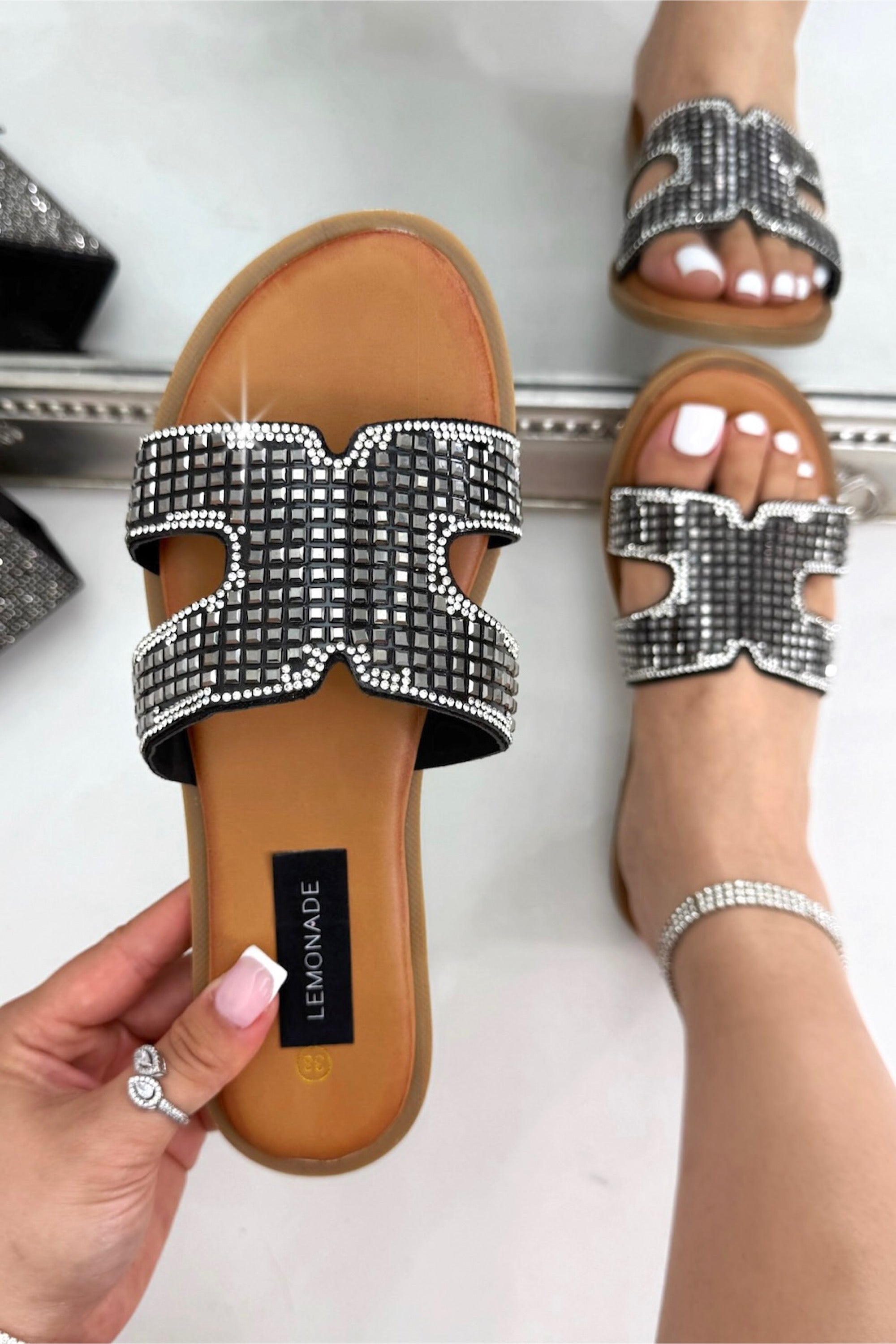 Sparkle Glow Halo Cut-Out Sliders Black, bringing attention to stylish cut-out strap design for a modern, elevated look